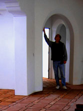 Jeff_Doubet Santa Barbara Home Designer inspecting drywall details on an interior Spanish archway in a Montecito, California home