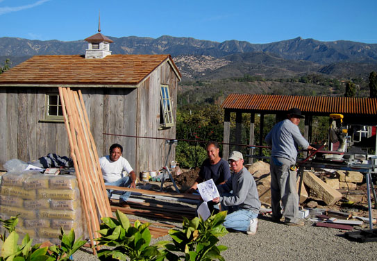 Young men at a custom shed and chicken coop construction site in Santa Barbara, California